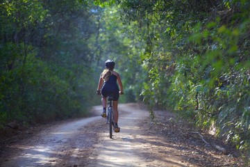 woman riding a bicycle in the mountains 