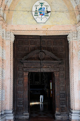 14th century wooden doors of Church of Santa Maria dei Servi (Chiesa di Santa Maria dei Servi) in Padua. Italy