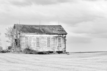 Old abandoned building in the country in black and white.