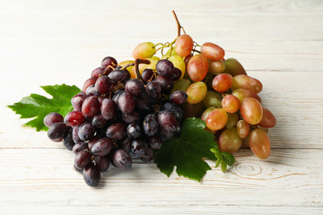 Fresh ripe grape on white wooden background