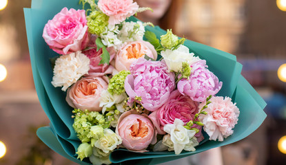 Fresh beautiful flower. Woman holding a big delicate flower bouquet of roses, peony, freesia and...