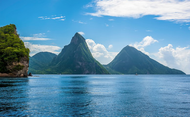 A view towards Soufriere Bay, St Lucia with the Pitons in the distance - obrazy, fototapety, plakaty