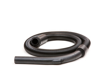 Black hose of the vacuum cleaner isolated on a white background . There is some free space for your...