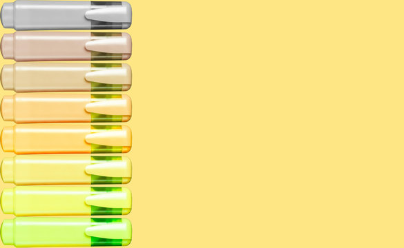 A set of markers for text and graphics of a yellow palette on a bright yellow background. School or office concept. Top view, flat lay, place for text, copy space.