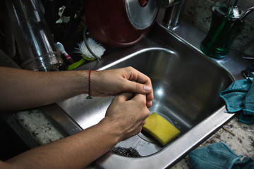 Washing dishes because in quarantine, dirty dishes do not stop.