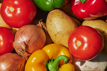 Macro shot of a basket of various vegetables in the sunlight.