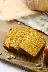 Gluten Free Pumpkin bread loaf set white cafe table.
