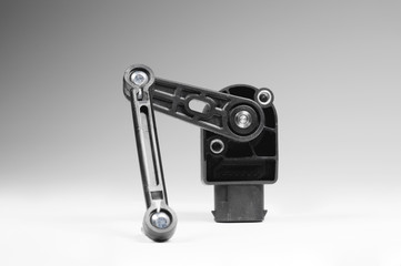 Chassis level sensor pins close-up on a white background. Electronic suspension sensor.