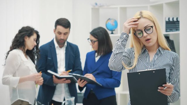4k slowmotion video of group of four young business people.