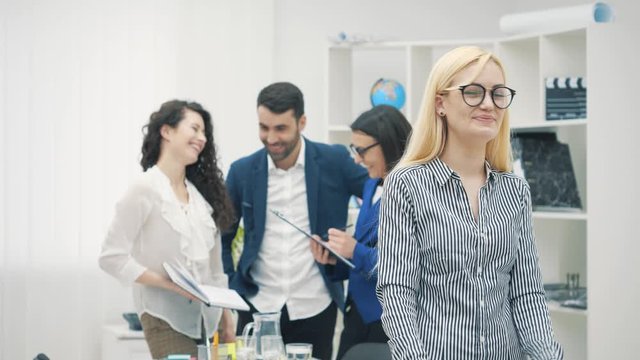 4k slowmotion video of group of four young business people.