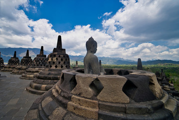 Buddha statue in Buddist temple of Borobudur in the morning. Yogyakarta. Java, Indonesia.
