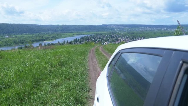 landscape of a rural road in a field, view from the side window of a car