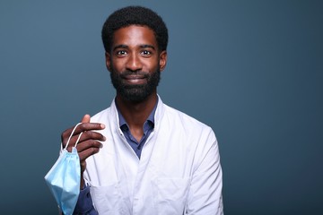 Beautiful afro doctor in front of a background