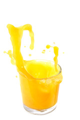 Naklejka na ściany i meble Orange juice splash in a glass on white background.
