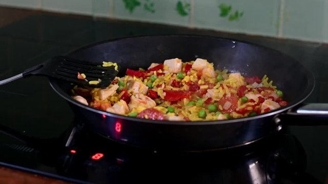 chicken chorizo cooking in frying pan giving off steam.