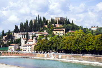 Panoramic view of Castel San Pietro (St. Peter Castle) on hill with cypress trees over the Adige River in Verona, Northern Italy.