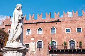 Statue of Dante located in front of historical red brick building at Piazza dei Signori located in Verona, Northern Italy.