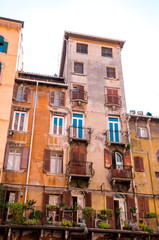 Naklejka premium Colorful facades of old houses with balconies on Piazza delle Erbe in old city Verona, Northern Italy.