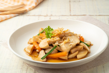 Stir Fried Mushrooms (Pleurotus Eryngii (King Oyster Mushroom)) with Oyster Sauce on white plate.