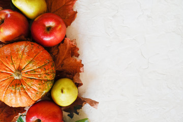 Naklejka na ściany i meble Pumpkin, fruits and autumn maple leaves. Autumn seasonal harvest concept. Healthy food.Copy space.