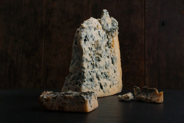 Close up of soft Italian cheese Gorgonzola on the dark wooden backround