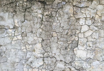 Wall background made of cracks. The texture of gray, dirty, cracked concrete.