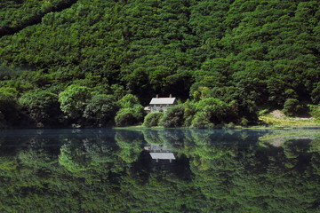 House reflections on a lake in Snowdonia National Park - 372986363