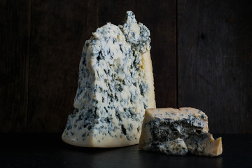 Close up of soft Italian cheese Gorgonzola on the dark wooden backround