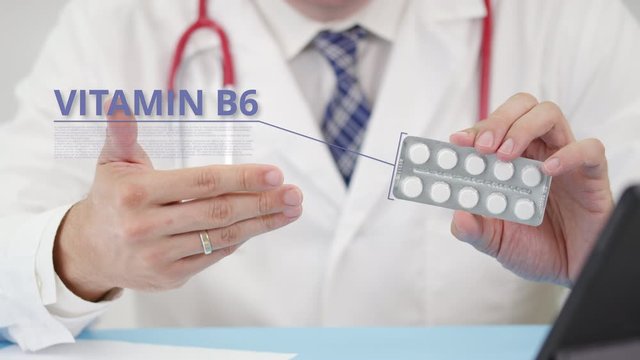 Medical doctor talks about Vitamin b6 tablets in his office. Telemedicine session with a patient