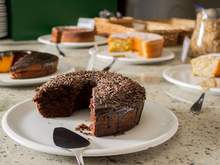 Mesa café da manhã com bolo de chocolate, bolo de cenoura, bolo de côco, bolo de milho