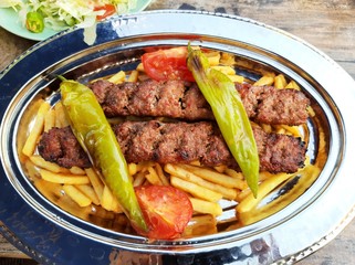 delicious Adana kebab and salads