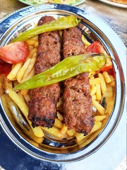 delicious Adana kebab and salads