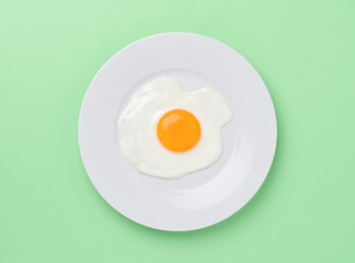 fried egg on green background