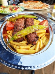 delicious Adana kebab and salads
