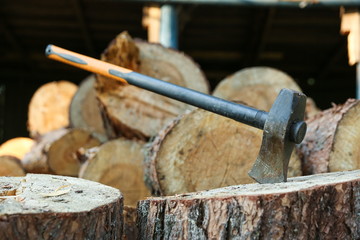 ax on a background of wooden firewood
