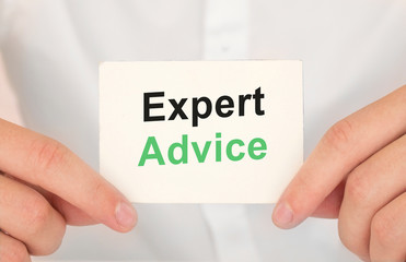 Man's hands take a card with words Expert advice, finance and business concept.