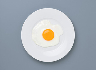 fried egg on turquoise gray background
