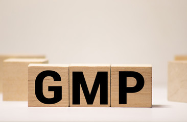 Good Manufacturing Practice. GMP the word on wooden cubes,