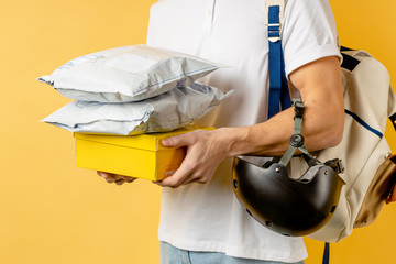 cropped unrecognizable pleasant guy working as courier or delivery, carrying packaging things for...