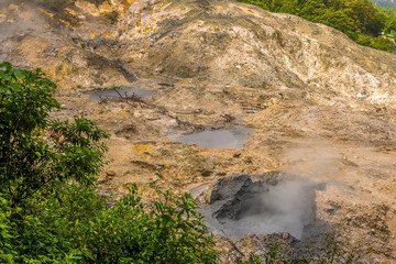 A view of three mud pools in the Sulphur Springs near to Soufriere in St Lucia