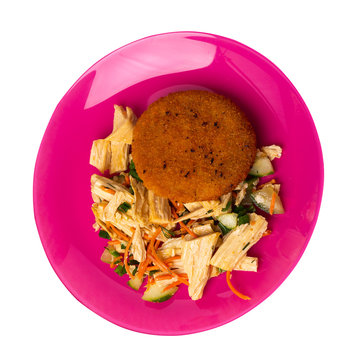 fishcake with soy asparagus and carrots, cucumbers and dilll.  fish cutlet on a plate isolated. cutlet with vegetables top view