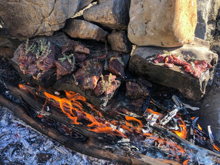 one of the natural methods of cooking meat in camping life
