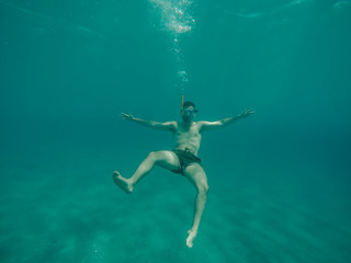 Obraz na płótnie Canvas Young boy diving under the sea.