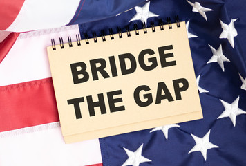 Fototapeta na wymiar Bridging the gap in text concept isolated on american flag