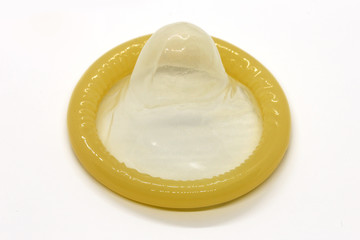 Classic rubber yellow condom on a white background