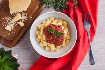 Gnocchi Bolognese in a white bowl.