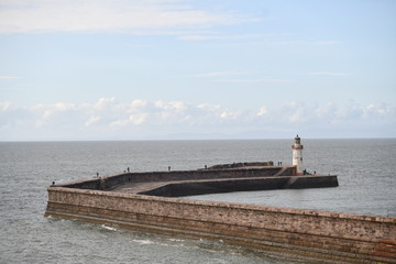 Fototapeta premium man walking on the pier