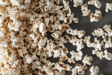 Overhead view of the fresh popcorn scattered on the dark grey background