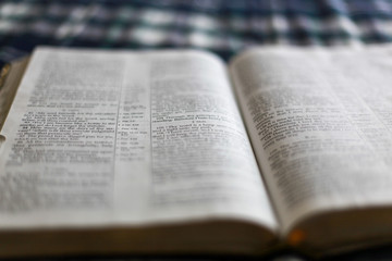 Closeup shot with linear tilt shift of the open Holy Bible