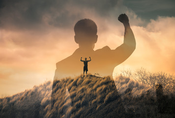 silhouette of man standing on top of mountain